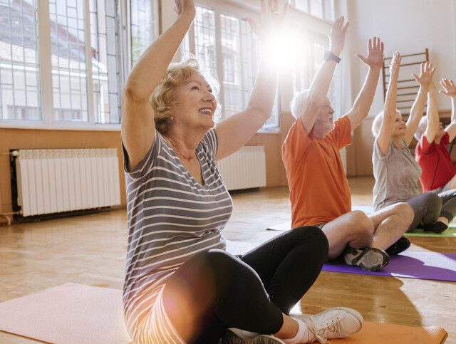 group of cheerful seniors having fun together exercising