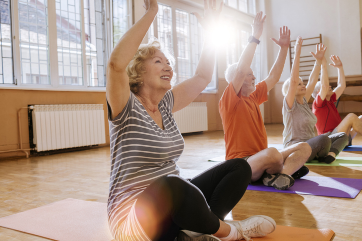 group of cheerful seniors having fun together exercising